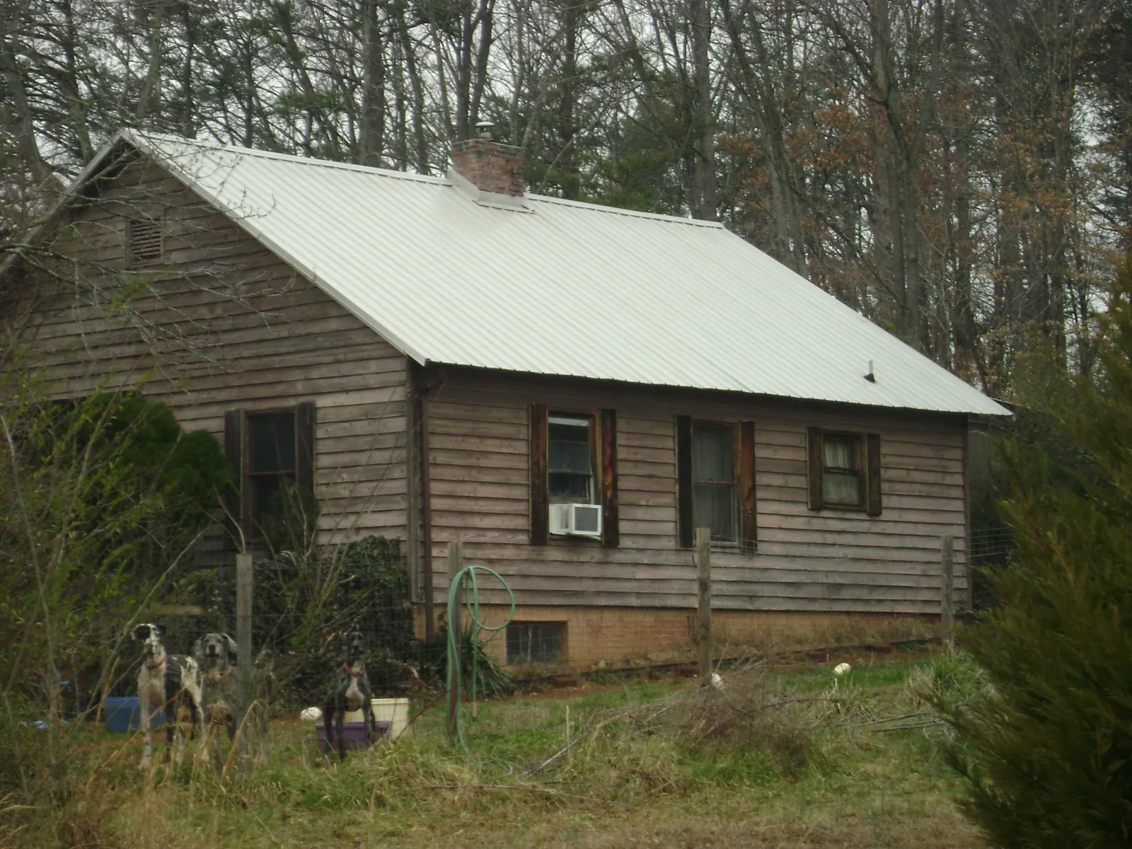 White metal roof on an old wood sided farmhouse, from a Metal Roof Installation job in Carbondale